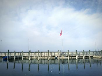 Flag by sea against sky