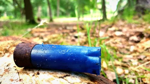 Close-up of blue tire on field