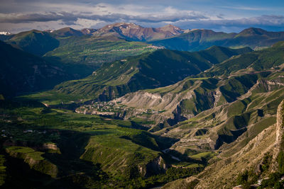 High angle view of land and mountains against sky