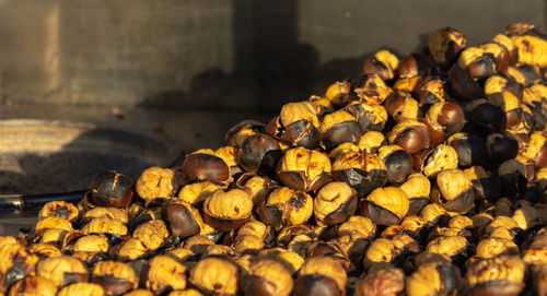 Close-up of baked chestnuts at a stand for cooking and selling.