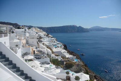 High angle view of townscape by sea against sky