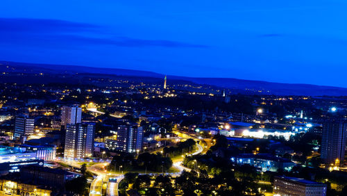 High angle view of city lit up at night