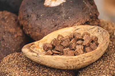 Homemade black rye cereal bread with hemp seeds in a traditional street food market, close up