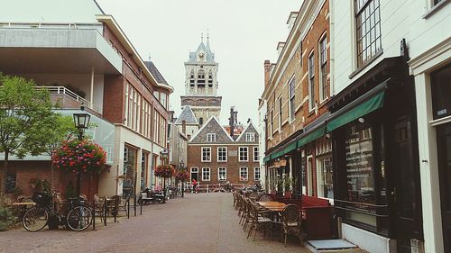 Street amidst buildings in city against sky