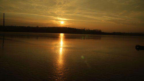 Scenic view of lake against sky during sunset