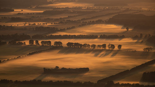 Aerial view of landscape against sky during sunset