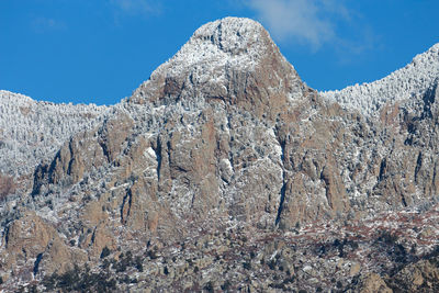 Low angle view of rock formation against sky