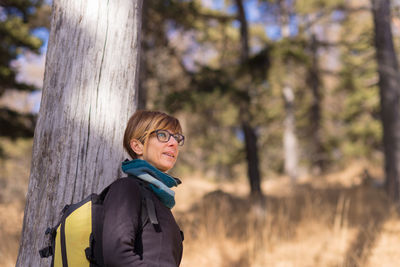 Portrait of smiling young woman in forest