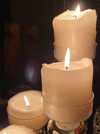 Close-up of lit tea light candles on table