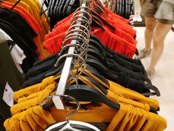 Low section of woman buying clothes at store