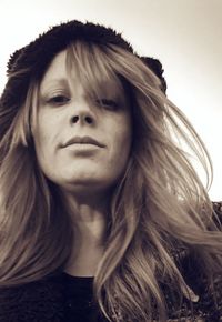 Close-up portrait of young woman against white background