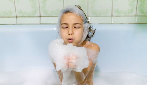 High angle view of boy washing hands in bathroom