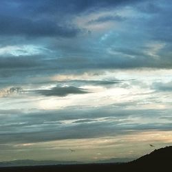 Scenic view of landscape against cloudy sky