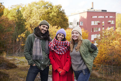 Smiling friends looking at camera