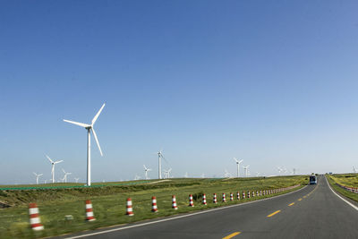 On both sides of the road are beautiful green prairies