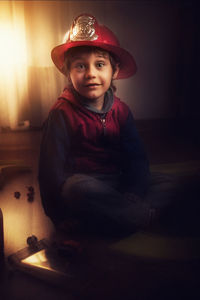 Portrait of cute boy sitting in hat