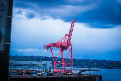 Crane at construction site against sky