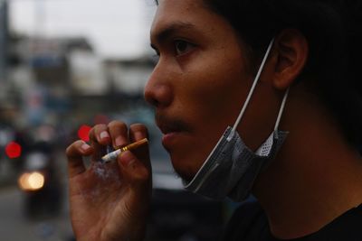 Cropped hand of woman applying nail