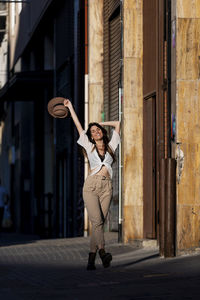 Woman walking by building