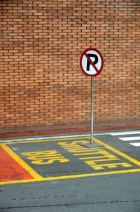 Road sign on brick wall