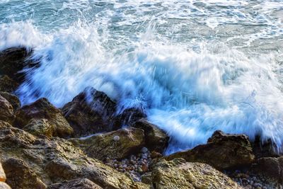 Waves splashing on rocks at shore