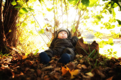 Portrait of woman relaxing in forest during autumn