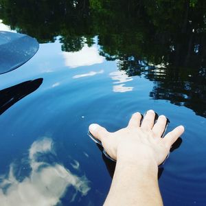 Low section of person standing in water