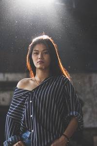 Young woman standing in abandoned building