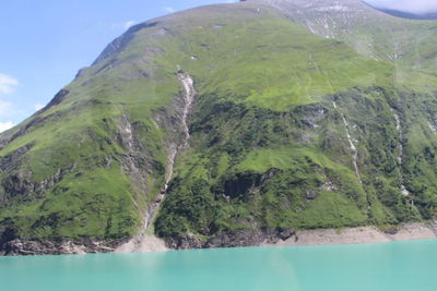 Scenic view of sea and mountains against sky