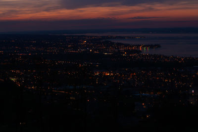 High angle view of illuminated city against sky at night