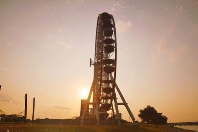 Low angle view of silhouette ferris wheel against sky during sunset