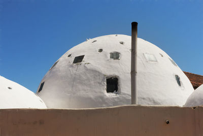 Low angle view of a turkish bath houseagainst blue sky