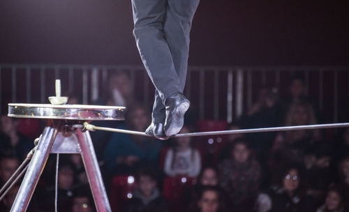 Low section of performer walking on tightrope during event