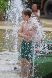 Full length of boy standing in water