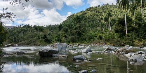 Scenic view of waterfall against sky