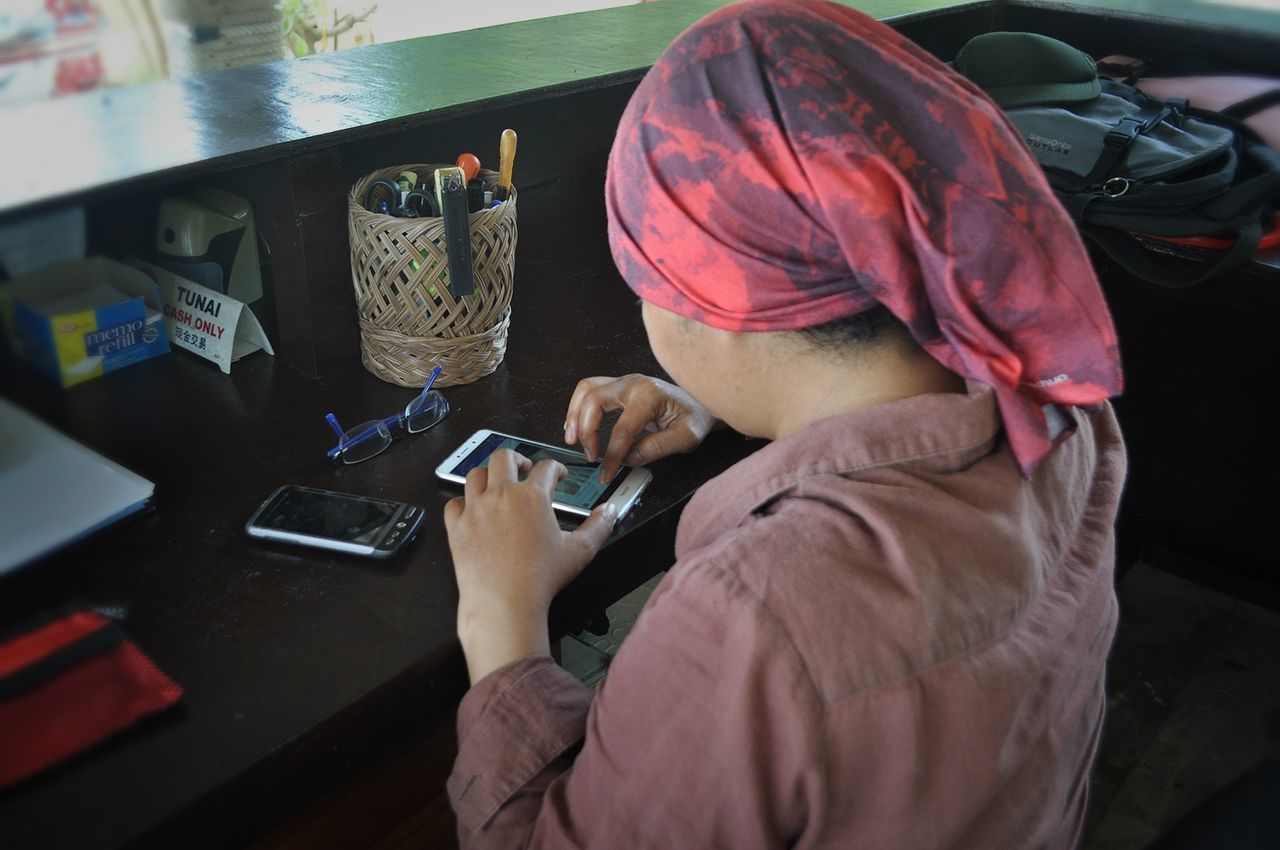 WOMAN USING SMART PHONE AT HOME