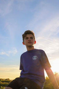 Portrait of boy against sky during sunset