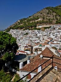 High angle view of buildings in town against clear sky