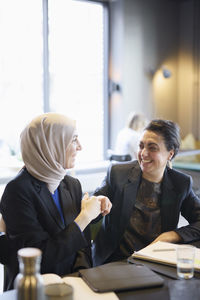 Businesswomen talking in cafe