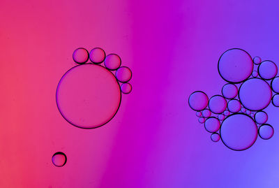 Close-up of bubbles over pink background