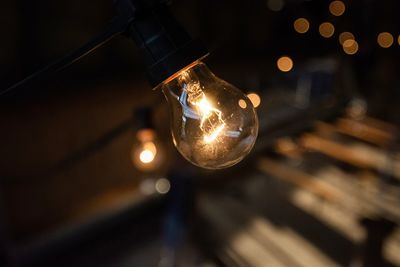 Low angle view of illuminated light bulb