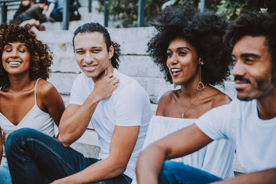 Portrait of smiling young women sitting outdoors