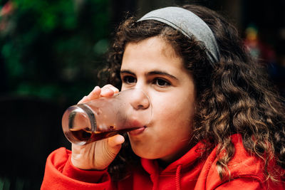 Close-up portrait of boy drinking coffee