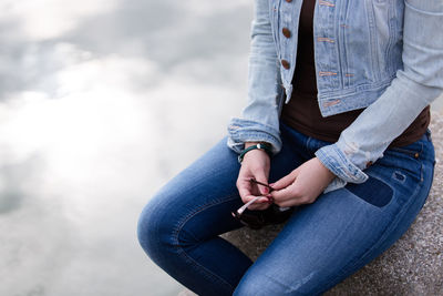 Midsection of couple sitting on floor