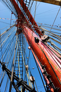 Low angle view of sailboat against clear blue sky