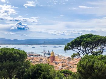 High angle view of townscape by sea against sky