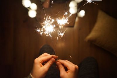 Midsection of person holding sparkler