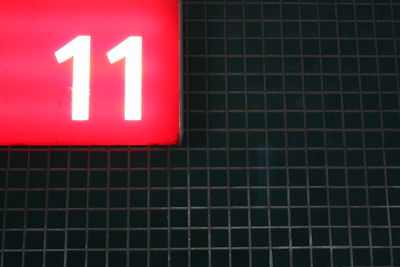 Close-up of red sign on wall