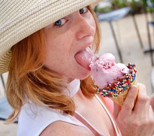 Portrait of woman eating ice cream outdoors