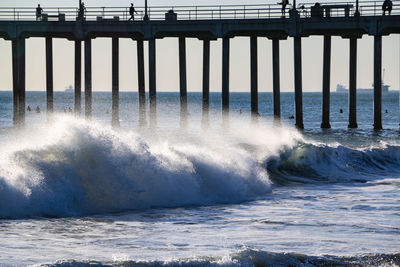 Water splashing on pier over sea